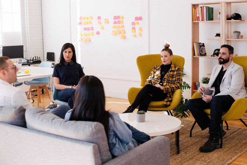 Team enjoying a relaxed meeting in a space that promotes office wellbeing