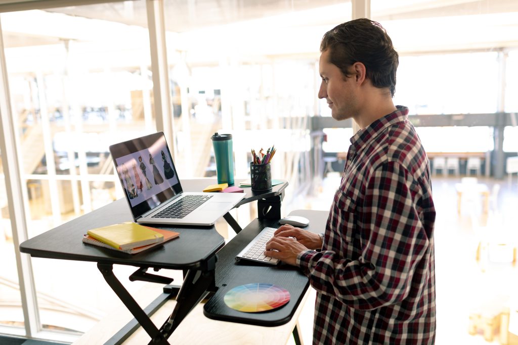 Employee at a standing-desk to promote office wellbeing